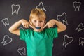 Six-year old boy shows myofunctional trainer. Helps equalize the growing teeth and correct bite, develop mouth breathing Royalty Free Stock Photo