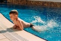 Six-year-old boy swimming in the outdoor pool at the hotel Royalty Free Stock Photo