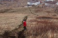 Six-year-old child in a red down jacket down the mountain and looks back