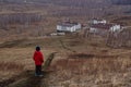 A six-year-old child in a red down jacket stands on a path outside the city and looks into the distance Royalty Free Stock Photo