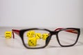 Six Yellow Dice on Clean Gray White Background Behind Glasses