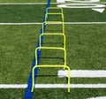 Six yellow mini hurdles set up on a field Royalty Free Stock Photo