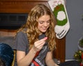 Sixteen Year Old Girl Enjoying A Christmas Gift In Her Home In Saint Louis, Missouri