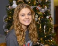 Sixteen yearold girl with a big smile posing in front of her Christmas tree in her home in Saint Louis, Missouri.