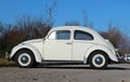 Sixties model of the famous vintage car Volkswagen Type 1, better known as beetle. Side view, whi