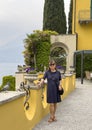 Sixty-five year-old female Korean tourist on a terrace in Varenna, Italy, on Lake Como. Royalty Free Stock Photo