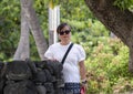 Sixty-three year old Korean tourist enjoying a visit to Kaloko Honokohau National Historic Park in Hawaii.