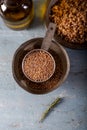 Siyez bulgur in metal measuring bowl on blue wooden table. Einkorn bulgur