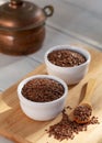 Siyez wheat bulgur in bowl and spoon on wooden background Royalty Free Stock Photo