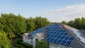 AI Generated Modern Residential Solar Panel System on Textured Roof with Lush Foliage and Sky Copy Space Royalty Free Stock Photo