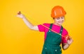 size. teen girl in hard hat and uniform. building and construction. concept of repair. Little girl using a measuring