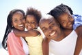 The size of their smiles shows how happy they are. Two parents giving their children a piggyback while on the beach. Royalty Free Stock Photo