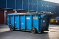 The sizeable blue dumpster, a robust iron container built for waste transportation Royalty Free Stock Photo