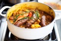 sizzle of sausages in a pan, before plating with mash