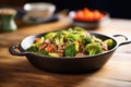 sizzling beef and broccoli skillet on a rustic table Royalty Free Stock Photo