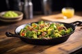 sizzling beef and broccoli skillet on a rustic table Royalty Free Stock Photo