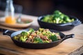 sizzling beef and broccoli skillet on a rustic table Royalty Free Stock Photo