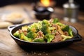 sizzling beef and broccoli skillet on a rustic table Royalty Free Stock Photo