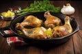 sizzling chicken legs with garlic butter in a cast-iron skillet