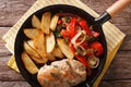 Sizzling Chicken with roasted potatoes and pepper close-up on a