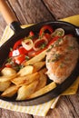 Sizzling Chicken with roasted potatoes and pepper close-up on a