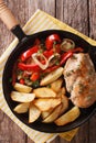 Sizzling Chicken with roasted potatoes and pepper close-up on a