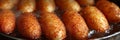 Sizzling golden brown corn dogs in the fryer, an irresistible and mouthwatering temptation