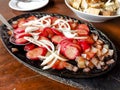 Sizzling Hotdog and onions, a popular Filipino appetizers or pulutan served in a restaurant or bar Royalty Free Stock Photo