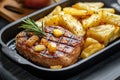A sizzling plate of gammon steak with pineapple and chips. Royalty Free Stock Photo