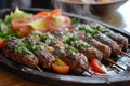 A sizzling platter of kebab halabi with Aleppo style minced meat. Royalty Free Stock Photo