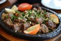 A sizzling platter of kebab halabi with Aleppo style minced meat. Royalty Free Stock Photo