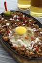Sizzling pork sisig, Filipino dish of chopped pig ears and snout, with onions, peppers and egg Royalty Free Stock Photo