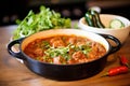 sizzling rogan josh in a traditional karahi pan