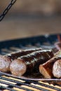 Sizzling sausage on a campfire at a barbecue event. Royalty Free Stock Photo