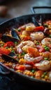 Sizzling seafood paella with mixed vegetables on a hot pan served in a vibrant kitchen