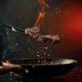 Sizzling steak leaps from pan, a culinary airborne spectacle