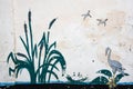 Skadovsk, Ukraine - June 15, 2017: Retro drawing on the limestone wall: bulrush, heron wandering along the water and looking for a