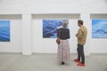 Skagen, Denmark, May, 2023: Visitors look at the paintings in gallery