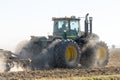 John Deere 9530 articulated 4WD tractor working a dry and dusty field in autumn Royalty Free Stock Photo