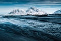 Skagsanden beach with snowy mountain and striped sand wave in winter at Lofoten Islands