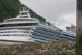SKAGWAY, ALASKA, JUN 26 2012: Princess Cruise ship docked in front of snow capped mountains Royalty Free Stock Photo