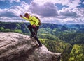 Skarner climb on mountain with trekking poles and backpack Royalty Free Stock Photo