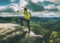 Skarner climb on mountain with trekking poles and backpack Royalty Free Stock Photo