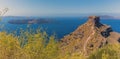 Skaros rock protrudes from Santorini`s caldera rim with views towards Nea Kameni Royalty Free Stock Photo