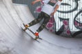 Skate park view with kids on a kick scooter doing tricks and stunts, boys in a skate park riding bmx bike and skate, playing and Royalty Free Stock Photo