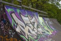 Skate ramp covered in Graffiti Art with trees in background Royalty Free Stock Photo