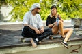 Skateboard boy and girl sitting and drinking water Royalty Free Stock Photo