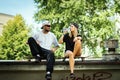 Skateboard boy and girl sitting and drinking water Royalty Free Stock Photo