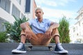 Skateboard, gen z and cool skater man in the city with a serious look outdoor. Portrait of a urban person from Mexico