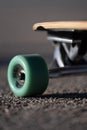 skateboard sitting in the pavement with its wheels off and top half broken